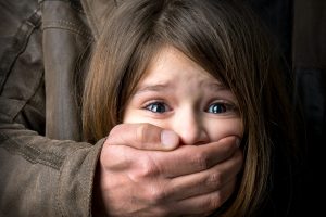 26747521 - scared young girl with an adult man's hand covering her mouth